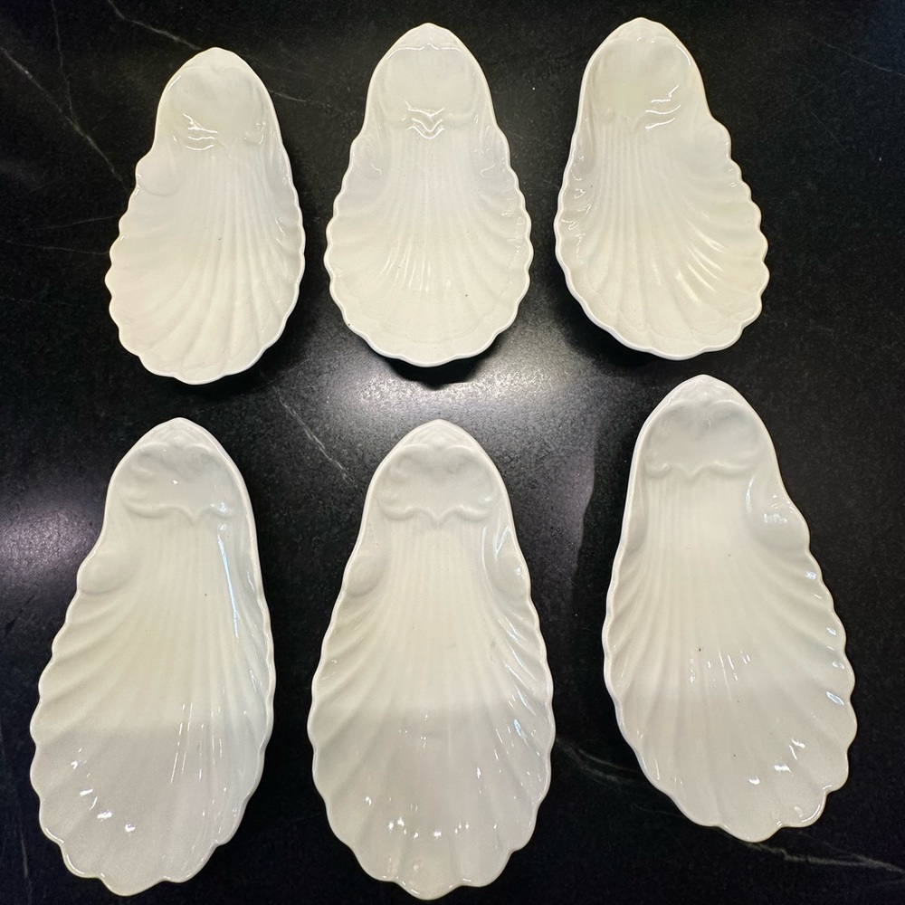 Six vintage white shell dishes .